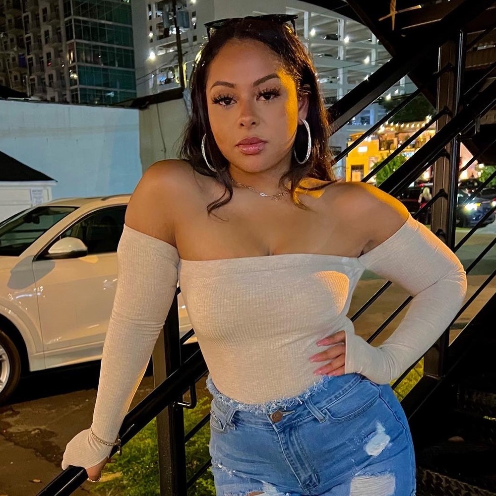 Off the shoulder cream bodysuit.